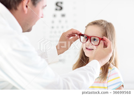 Child at eye sight test. Kid at optitian. Child at eye sight test. Kid at optitian. 36699568