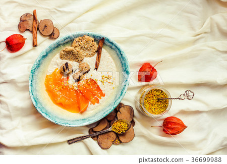 Oatmeal smoothies bowl with persimmons, raw sweets 36699988
