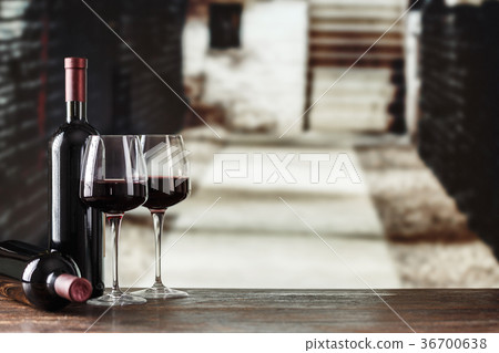 Wine cellar with wine bottle and glasses. 36700638
