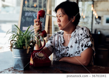 Asian women angry phone call in a coffee shop Asian women angry phone call in a coffee shop 36701041