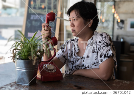 Asian women angry phone call in a coffee shop Asian women angry phone call in a coffee shop 36701042