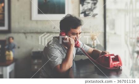 Asian man angry phone call in a coffee shop Asian man angry phone call in a coffee shop 36701116