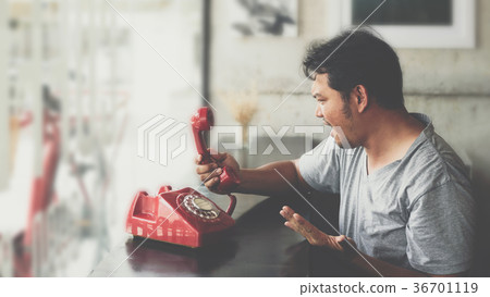 Asian man angry phone call in a coffee shop Asian man angry phone call in a coffee shop 36701119