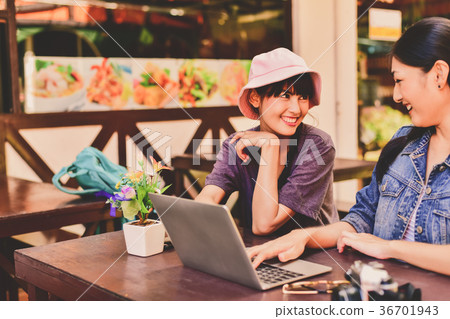 A tourist girl searching for accommodation on the internet and m 36701943