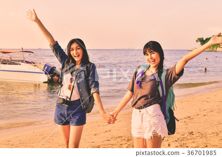 Beautiful girl is walking on the beach happily. 36701985