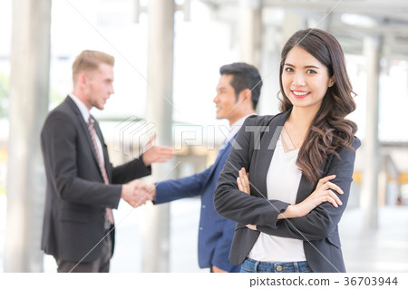 Young Beautiful business woman in city looking out and thinking Young Beautiful business woman in city looking out and thinking 36703944