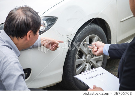 Man agent Filling Insurance Form Near Damaged and examining Car, 36705708