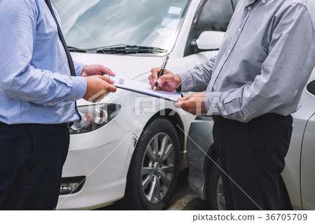 Insurance Agent examine Damaged Car and customer filing signatur Insurance Agent examine Damaged Car and customer filing signatur 36705709