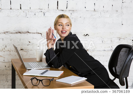 Young blond beauty businesswoman sitting at a Young blond beauty businesswoman sitting at a 36706189