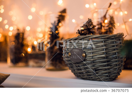 Branches of spruce with cones in the basket under 36707075