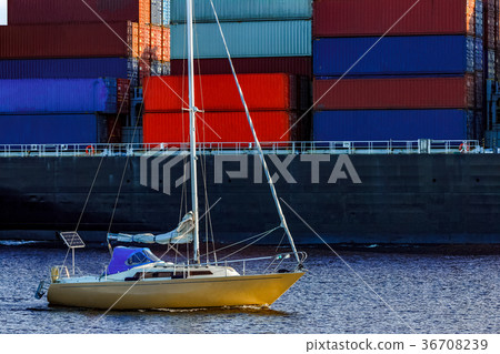 Yellow sailboat against cargo ship Yellow sailboat against cargo ship 36708239