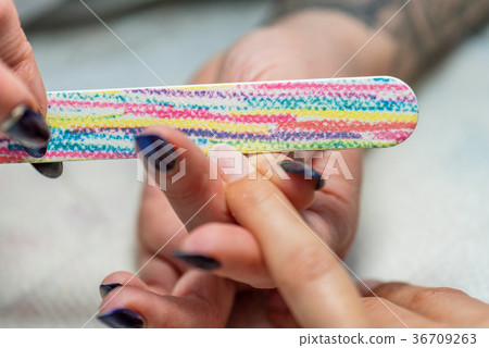 Manicure treatment at nail salon. Manicure treatment at nail salon. 36709263