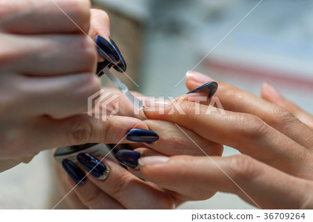 Manicure treatment at nail salon. 36709264