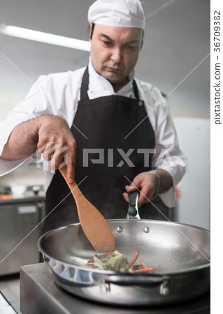 chef works restaurant kitchen preparing meal 36709382