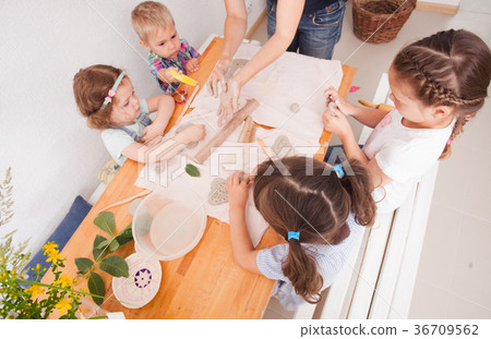 Happy children are engaged with modeling clay Happy children are engaged with modeling clay 36709562