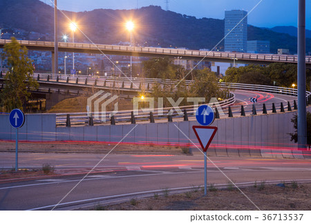View of city highway in dusk with trace of blurred headlights 36713537