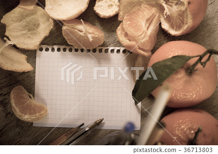 Empty notebook pages and tangerines 36713803