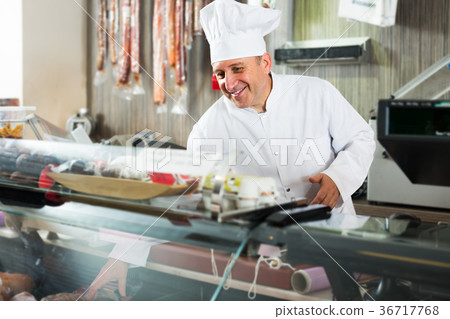 butcher with wurst at counter 36717768