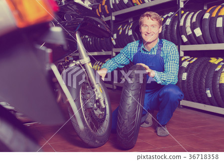 Man working with bike tires 36718358