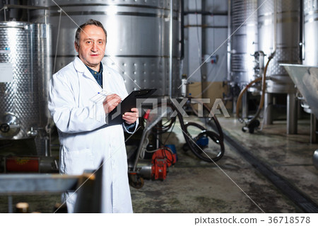 Wine maker examines equipment at winery Wine maker examines equipment at winery 36718578