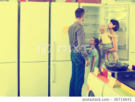 family of four shopping new refrigerator in home appliance store 36718641
