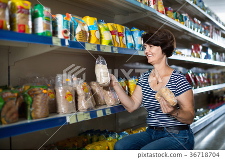 Pensioner selecting a groats at the store Pensioner selecting a groats at the store 36718704