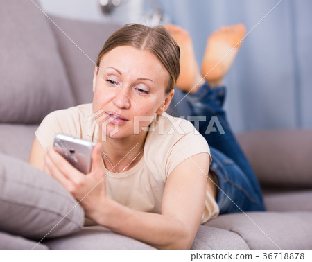 Woman resting with phone 36718878