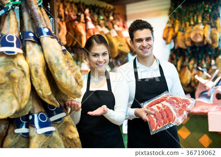 Portrait of sellers offering tasty jamon Portrait of sellers offering tasty jamon 36719062