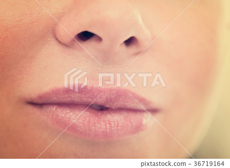 Close-up of woman's lips with natural lipstick make up. macro lipgloss make-up Close-up of woman's lips with natural lipstick make up. macro lipgloss make-up 36719164