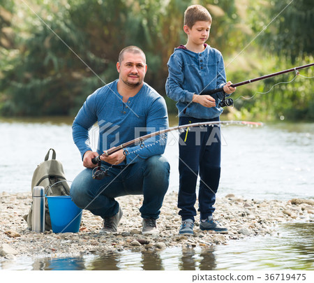 father and son fishing in wild river. 36719475