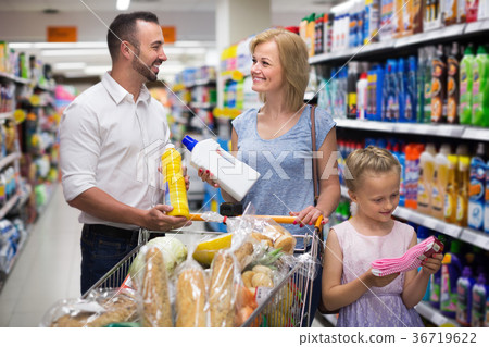 Family with daughter choosing cleaning products Family with daughter choosing cleaning products 36719622