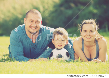 family lying in the grass. family lying in the grass. 36719676