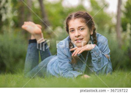 portrait of teenager while lying in summer green park 36719722