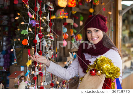 Girl choosing Christmas decoration 36719770