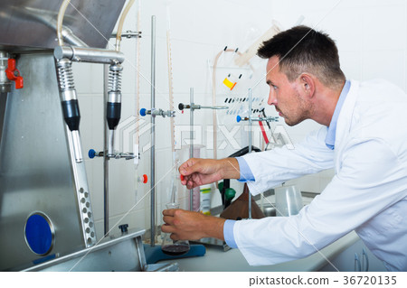Young man working on quality of products in lab 36720135