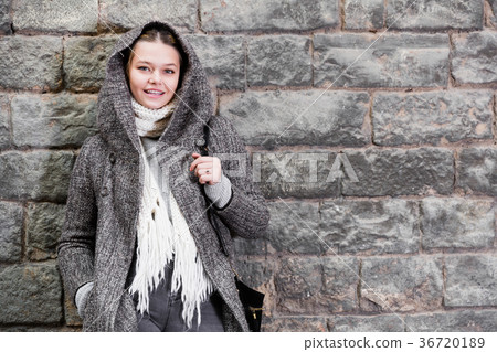 teenager girl in hood near wall 36720189