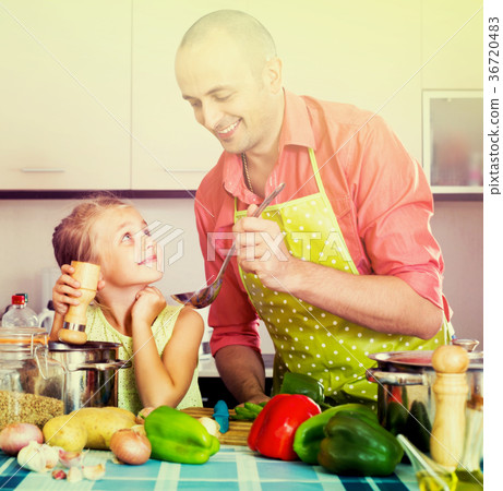 girl helping father to prepare dinner 36720483