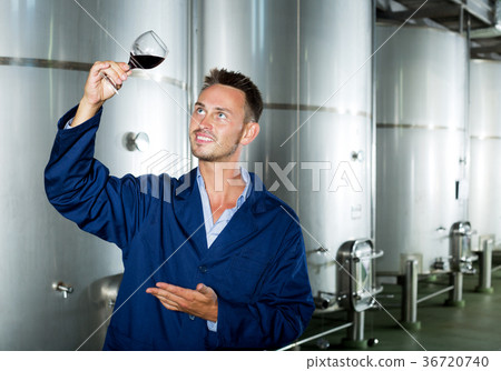 Man in uniform looking at wine Man in uniform looking at wine 36720740