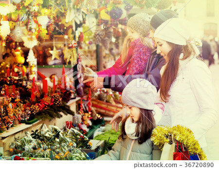 Family standing at coniferous souvenirs counter 36720890