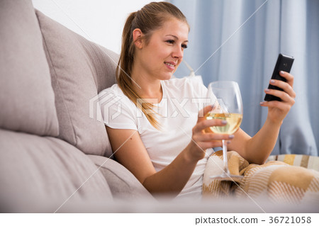 Young female with modern mobile and wine 36721058