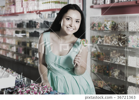 Portrait of sexy young woman with candy 36721363