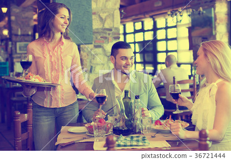 Adults having dinner and waiter 36721444