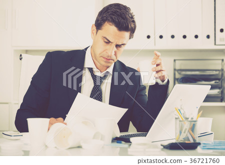 Tired man working in hot office Tired man working in hot office 36721760