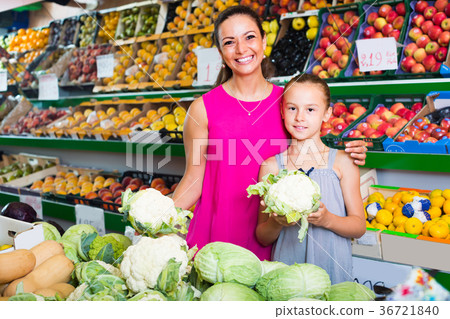 woman with girl buying cabbage 36721840
