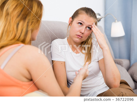 Young female is unhappy and girlfriend is comforting her 36722096
