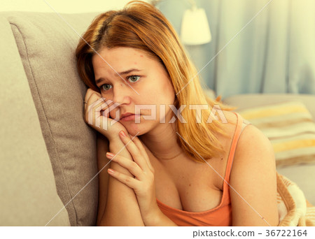 sad female on cozy sofa at home 36722164