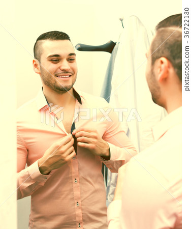 Man trying on new shirt Man trying on new shirt 36722180
