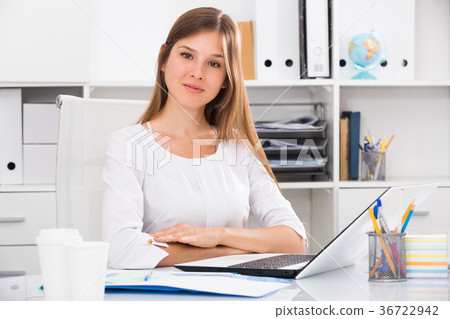 Smiling businesswoman at work office 36722942