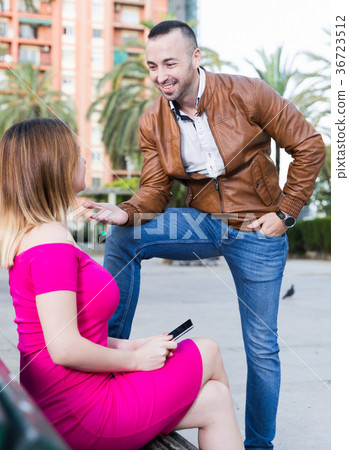 Stranger man is talking with young female who is resting Stranger man is talking with young female who is resting 36723512