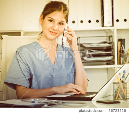 Female doctor consulting patient on phone Female doctor consulting patient on phone 36723526